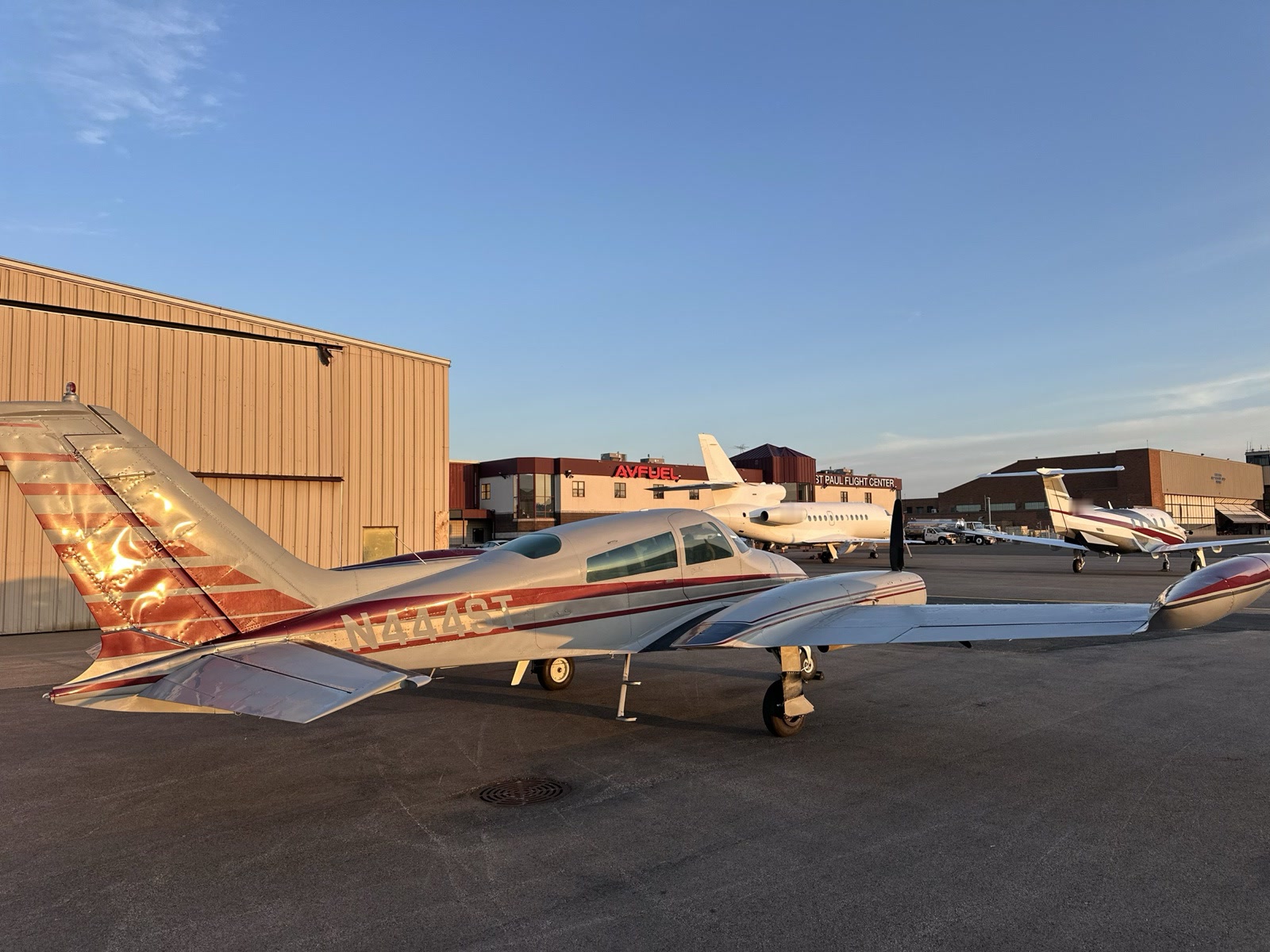 The tail of N444ST catching low evening sun on the ramp