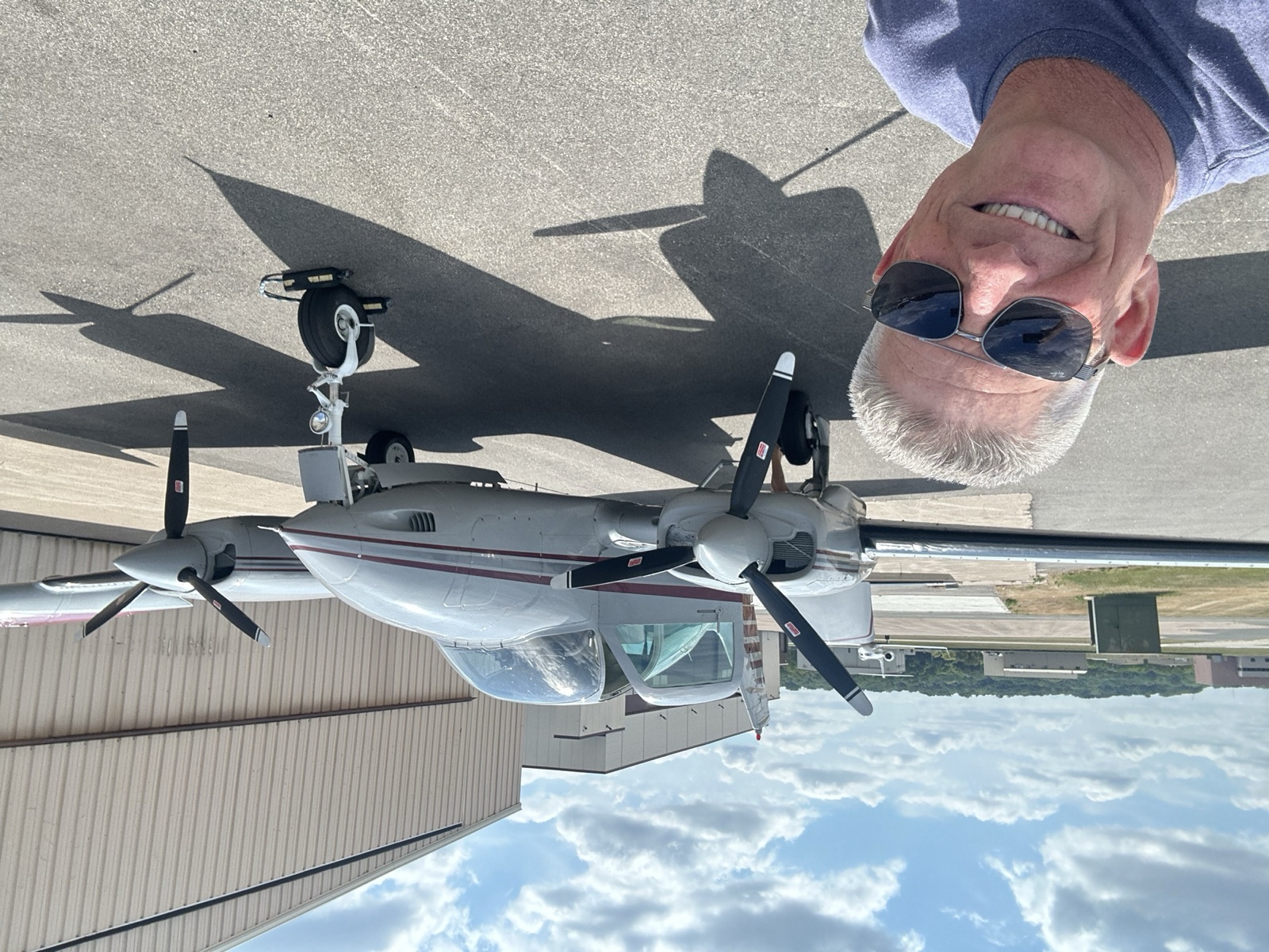 The aircraft on the ramp under high summer cloud