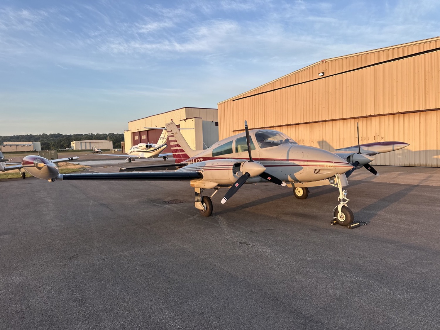 N444ST in profile on the ramp in low evening light