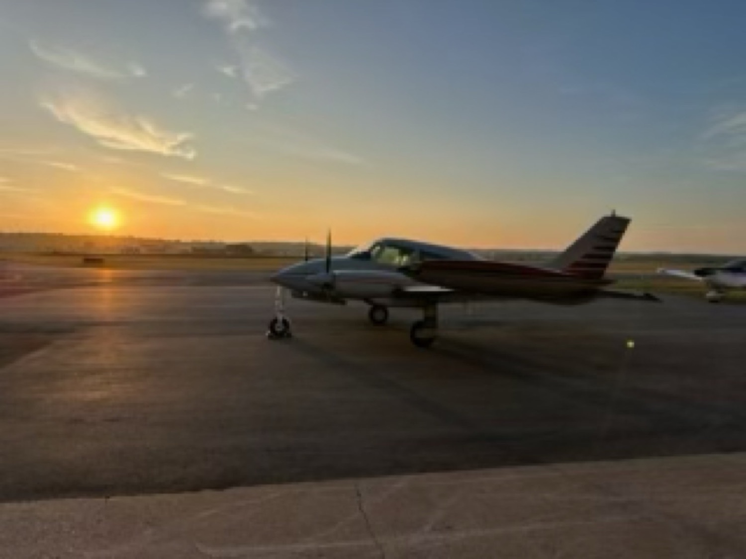 N444ST on the ramp with the sun low on the horizon