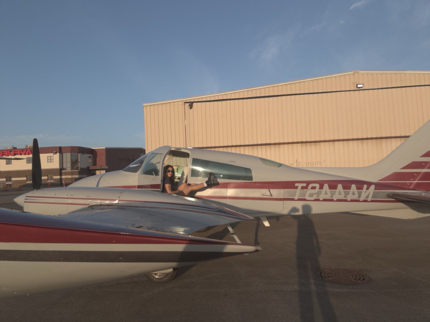 Sitting in the cabin doorway of N444ST, tail number visible